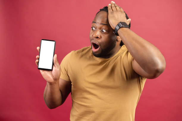 istock Young modern african man showing smartphone blank screen 1314206502