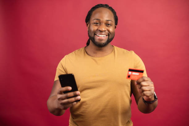 istock African American man holding credit card 1314206540