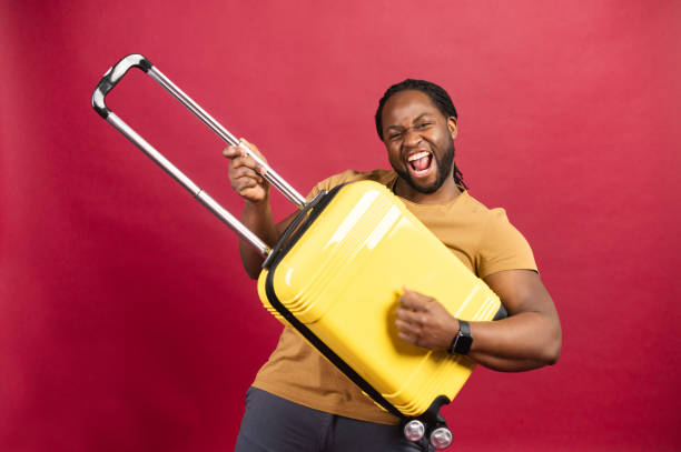 istock Young African American man with yellow suitcase 1314206634
