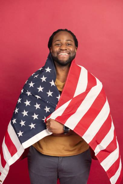 istock Smiled black muscular man covered with american flag 1314206662