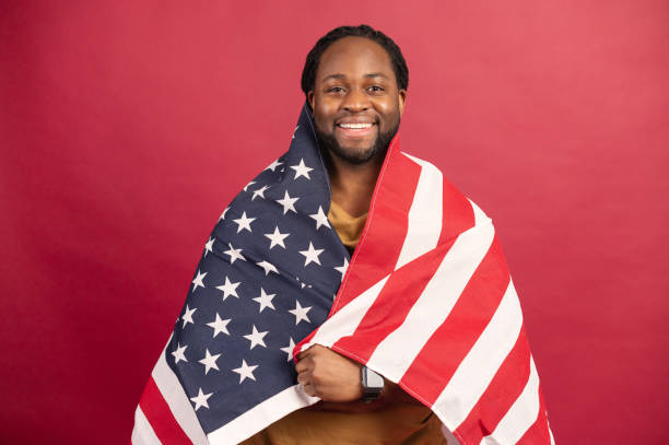 istock Smiled black muscular man covered with american flag 1314206666
