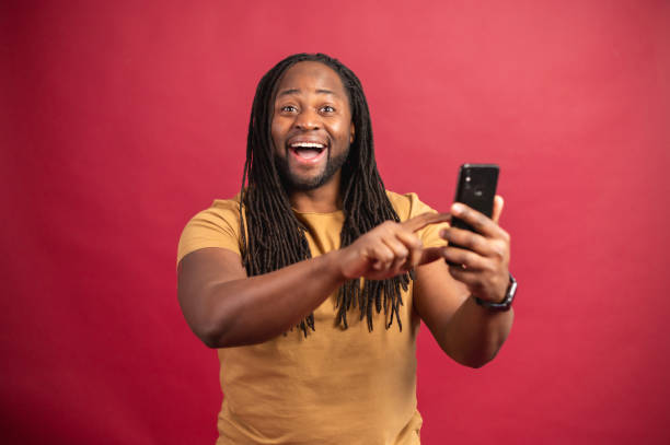 istock Amazed dark skinned man looking at the phone screen 1314207008