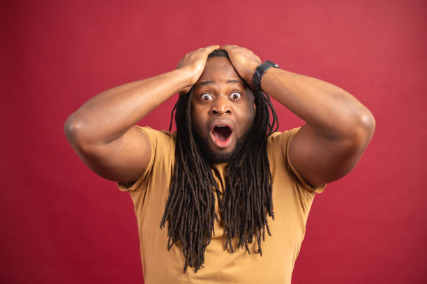 istock Shocked African-American guy isolated on red 1314207090