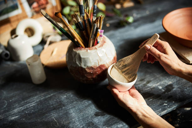 istock Female potter hands painting pottery in workshop 1314207906