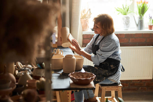istock Charming female potter polishing earthenware in workshop 1314207983