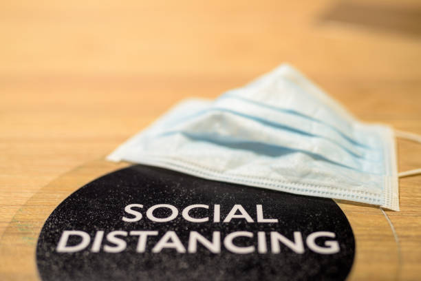 istock Social distancing text and face mask on table at restaurant 1314208231
