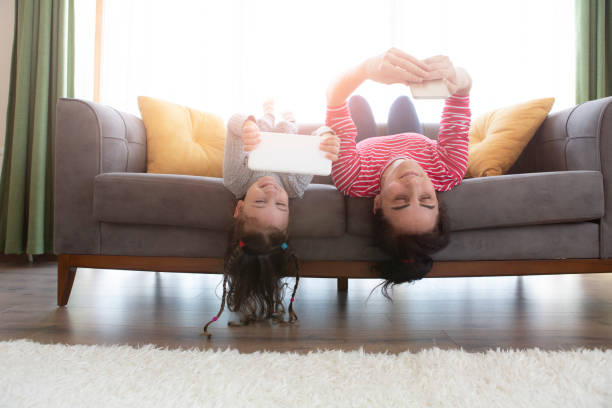 istock Mom and little daughter relax using tablet and smart phone together 1314209258