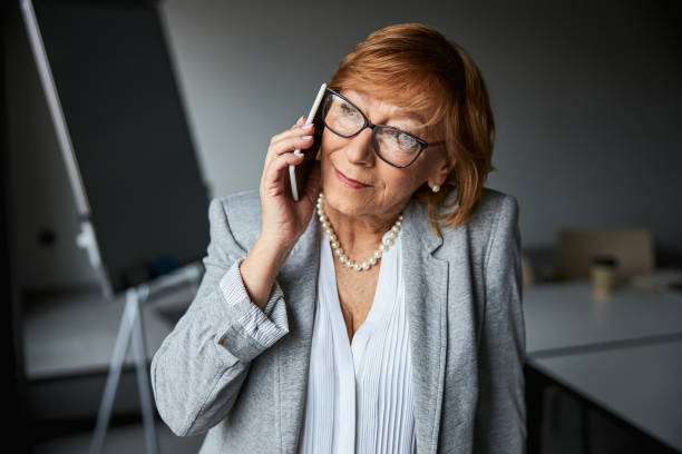 istock Mature joyful woman having pleasant telephone talk 1314211422
