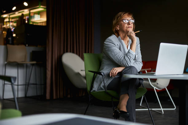 istock Cheerful mature woman thinking about successful results 1314211435