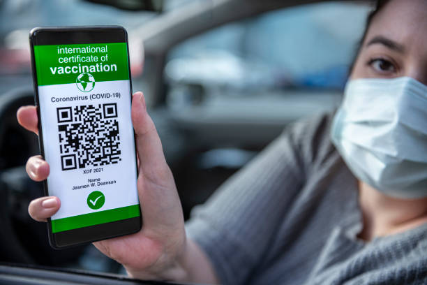 istock Female driver is showing her immunization certificate app. 1314212550