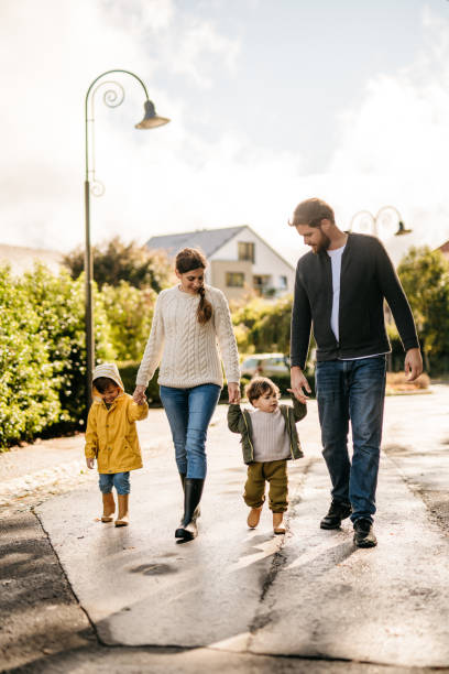 Young family holding hands on a walk