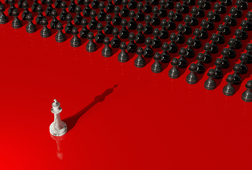 White chess king facing an army of black pawns. Power struggle, coup, class conflict concept. Digital 3D rendering.