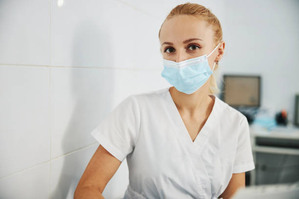 istock Dental clinic worker watching camera while sitting in mask 1314217456