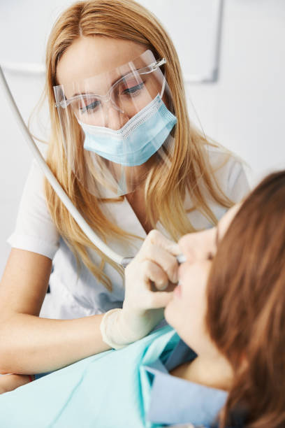 istock Caring dental expert removing caries from boy teeth with handpiece 1314217598