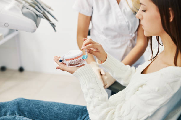 istock Female patient brushing dental impression with toothbrush 1314217626