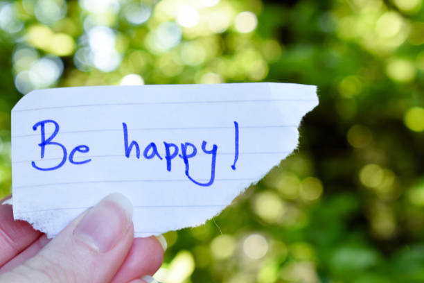 istock Hand holding a paper with be happy text 1314218608