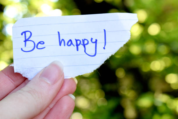 Human hand holding a baner be happy in nature