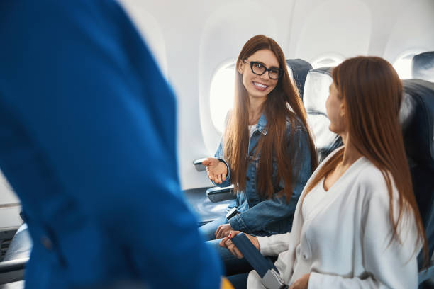 istock Two ladies communicating in the plane and smiling 1314219552