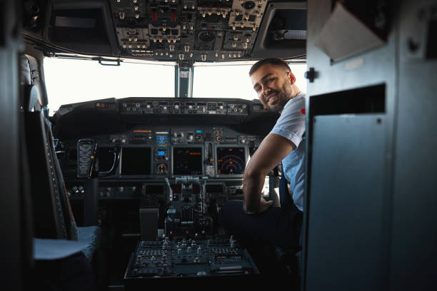 istock Mirthful experienced pilot looking happy at his workplace 1314219586