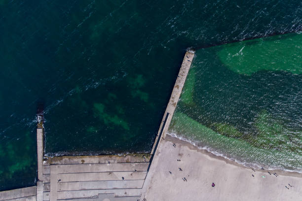 istock Sandy beach, concrete pier, clear sea water. Helicopter view. 1314220400