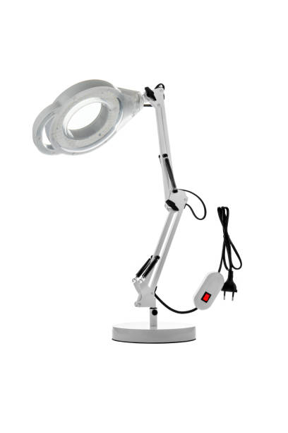 istock Table lamp with a magnifying glass. Magnifying glass with illumination on a white background. 1314221965