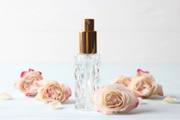 istock Perfume bottle and rose flowers on a light background close up 1314225156