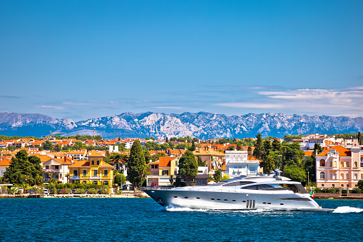 Zadar waterfront and speedboat yacht view, Velebit mountain background, Dalmatia archipelago of Croatia