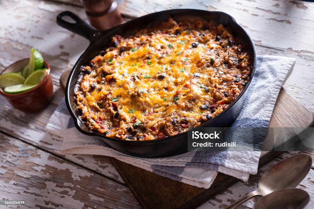 Shredded Chicken Skillet Southwestern Shredded Chicken Skillet with Rice, Black Beans, Tomato and Cheese Casserole Stock Photo