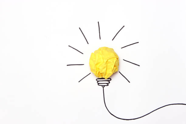 istock creative concept idea. Painted light bulb with a crumpled paper yellow ball. 1314226875