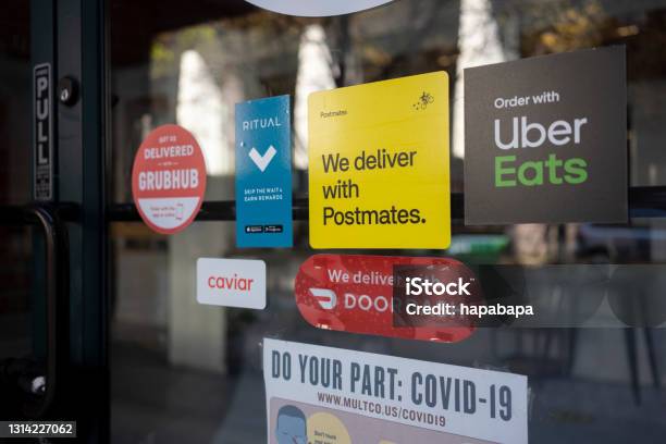 Food Delivery Services Amid The Pandemic Stock Photo - Download Image Now - DoorDash, Grubhub, Delivering