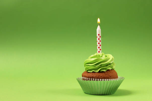 istock Delicious cupcake with a candle on a colored background with space for text. 1314227101