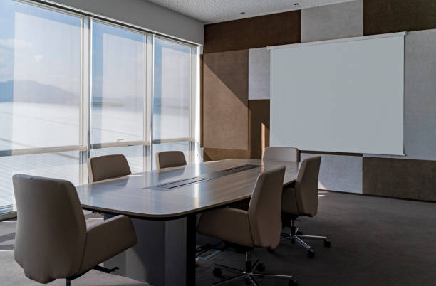 istock Modern empty meeting room against large windows in office 1314227107