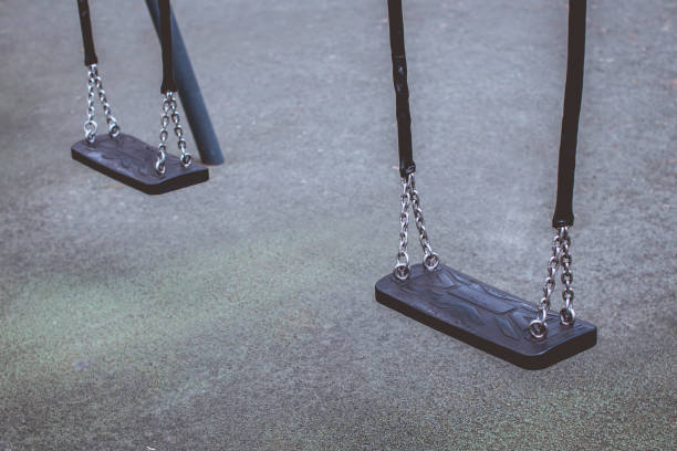 istock Two Empty Swings in the Playground 1314227848