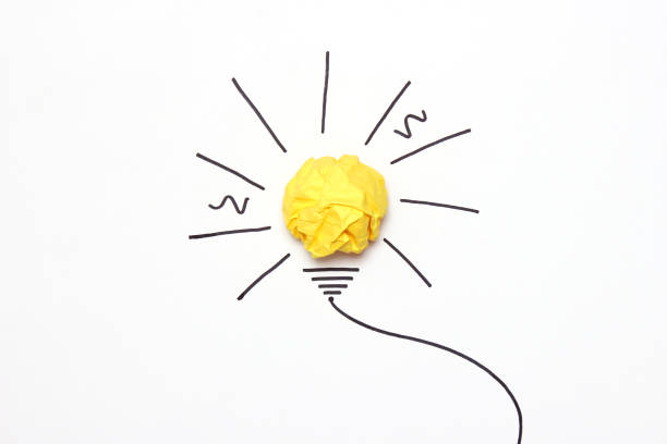 istock creative concept idea. Painted light bulb with a crumpled paper yellow ball. 1314229741