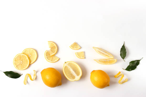 istock lemons and green leaves on a colored background. 1314229775