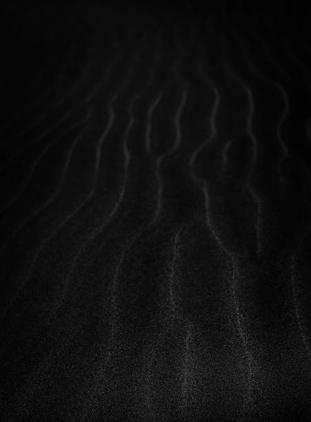 istock Black Sand dune. Black Sand beach macro photography. Background, texture, wave pattern of oceanic sand on the beach, black. Texture of beach sand. Black beach. 1314229980