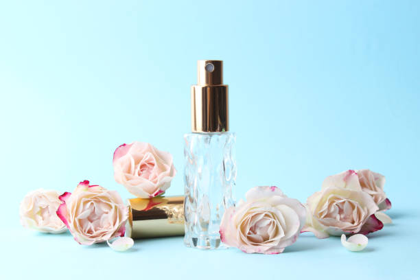 istock Perfume bottle and rose flowers on a light background close up 1314231915