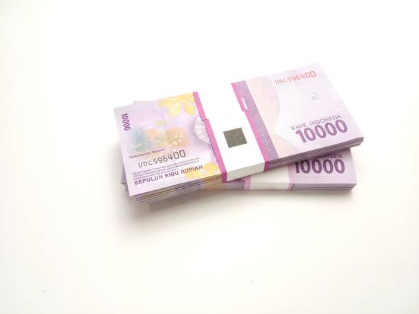 istock flat lay, stack of bundle Ten Thousand Rupiah Indonesia Money, at White Background 1314232709