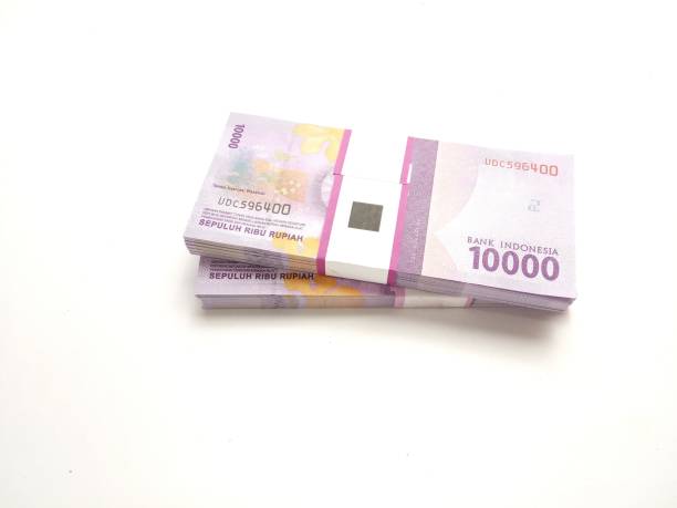 istock flat lay, stack of bundle Ten Thousand Rupiah Indonesia Money, at White Background 1314232809