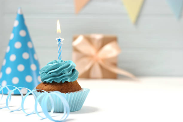 istock Delicious cupcake with a candle on a colored background 1314235000