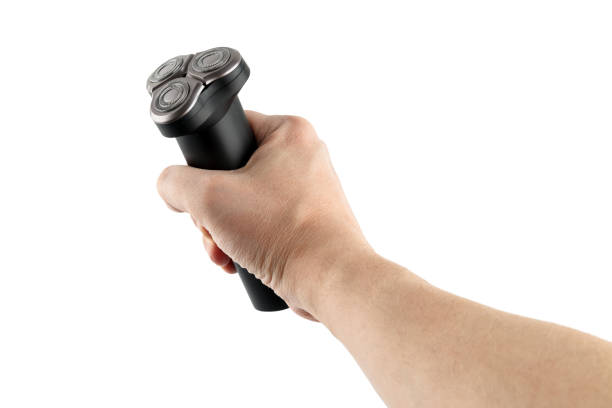 istock bare caucasican hand holding three razor black electric shaver - isolated 1314235746