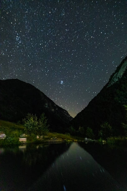 istock Starry sky and milky way with bright stars over mountains. 1314238922