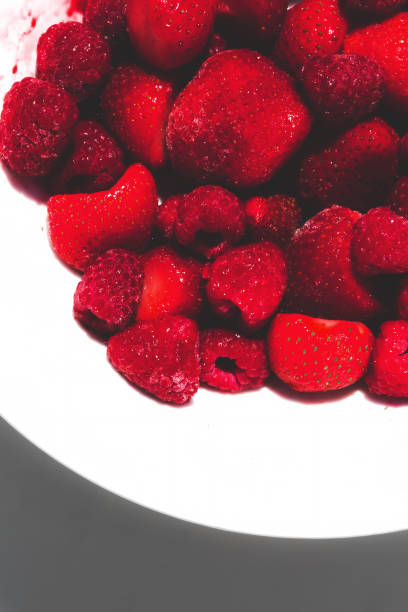 istock Strawberries on white plate in natural light. 1314240723