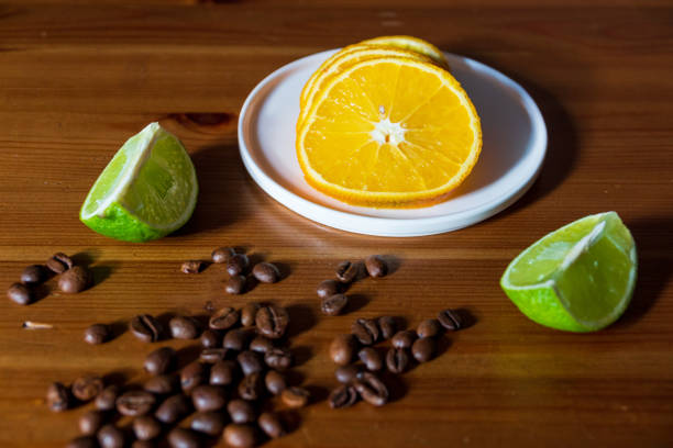 Sliced orange and lime with coffee beans