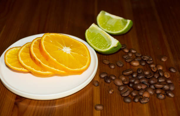 Sliced orange and lime with coffee beans