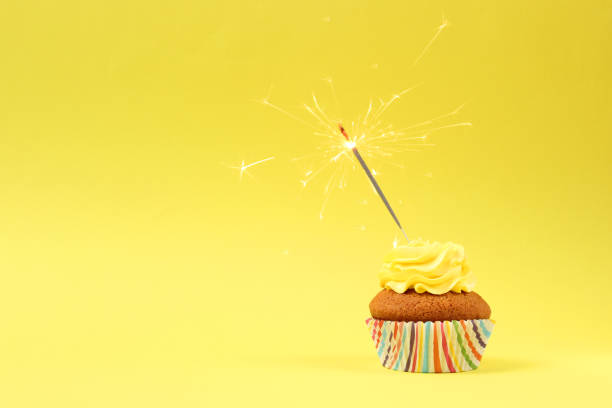 istock Delicious cupcake with a candle on a colored background with space for text. 1314241849