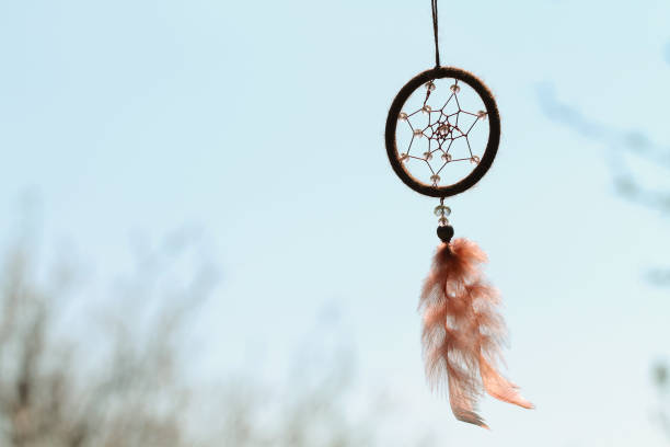 istock Dreamcatcher with crystal beads on the sky background. 1314242826