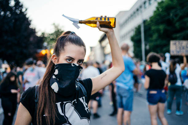 istock Young female protester with Molotov cocktail 1314243531