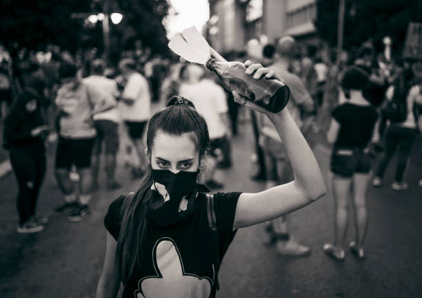 istock Young female protester with Molotov cocktail 1314243803