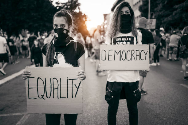 istock Young women protesters holding placards 1314243889